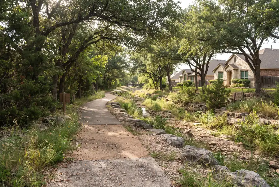 Suburban greenbelt path with live oaks in Encino Park, north San Antonio