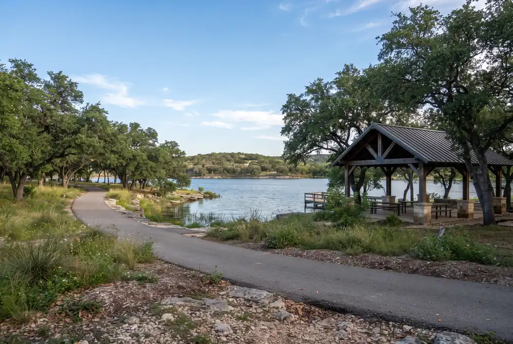 Lakeside park with a pavilion and oak trees in Timberwood Park, Texas